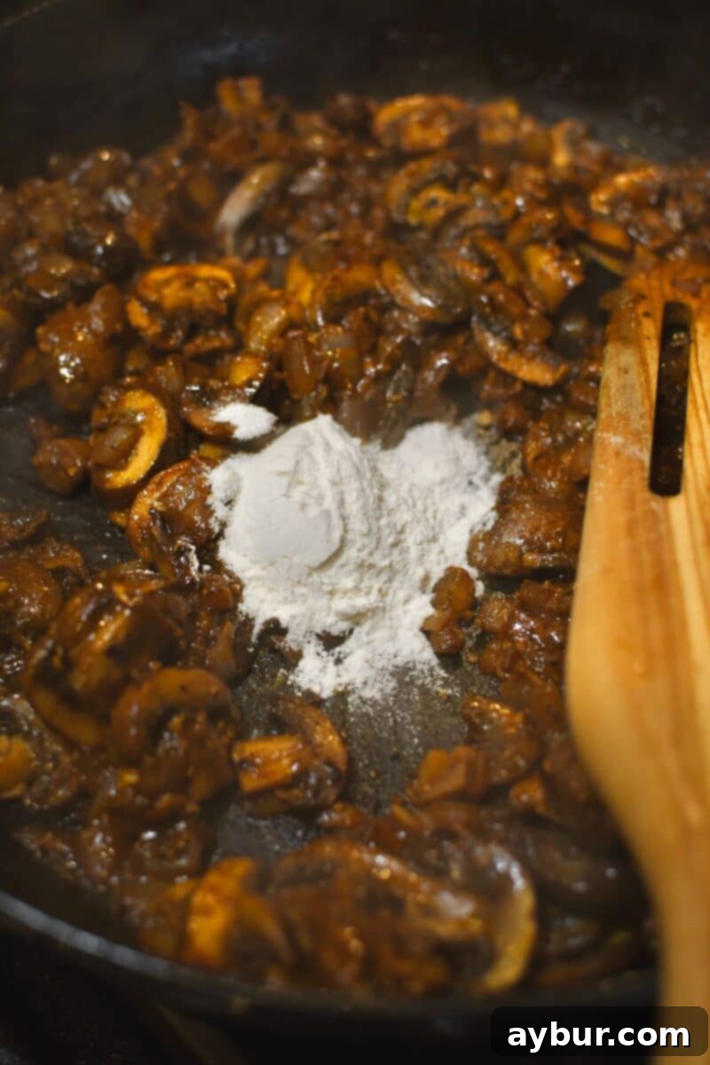 Creamy Chicken Stroganoff 10 Adding flour to create a roux, thickening the stroganoff sauce.