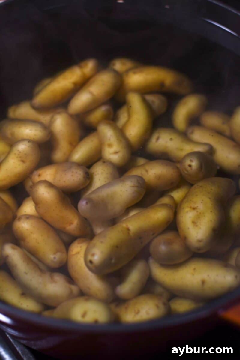 Potatoes placed in boiling water to be par cooked before smashing.