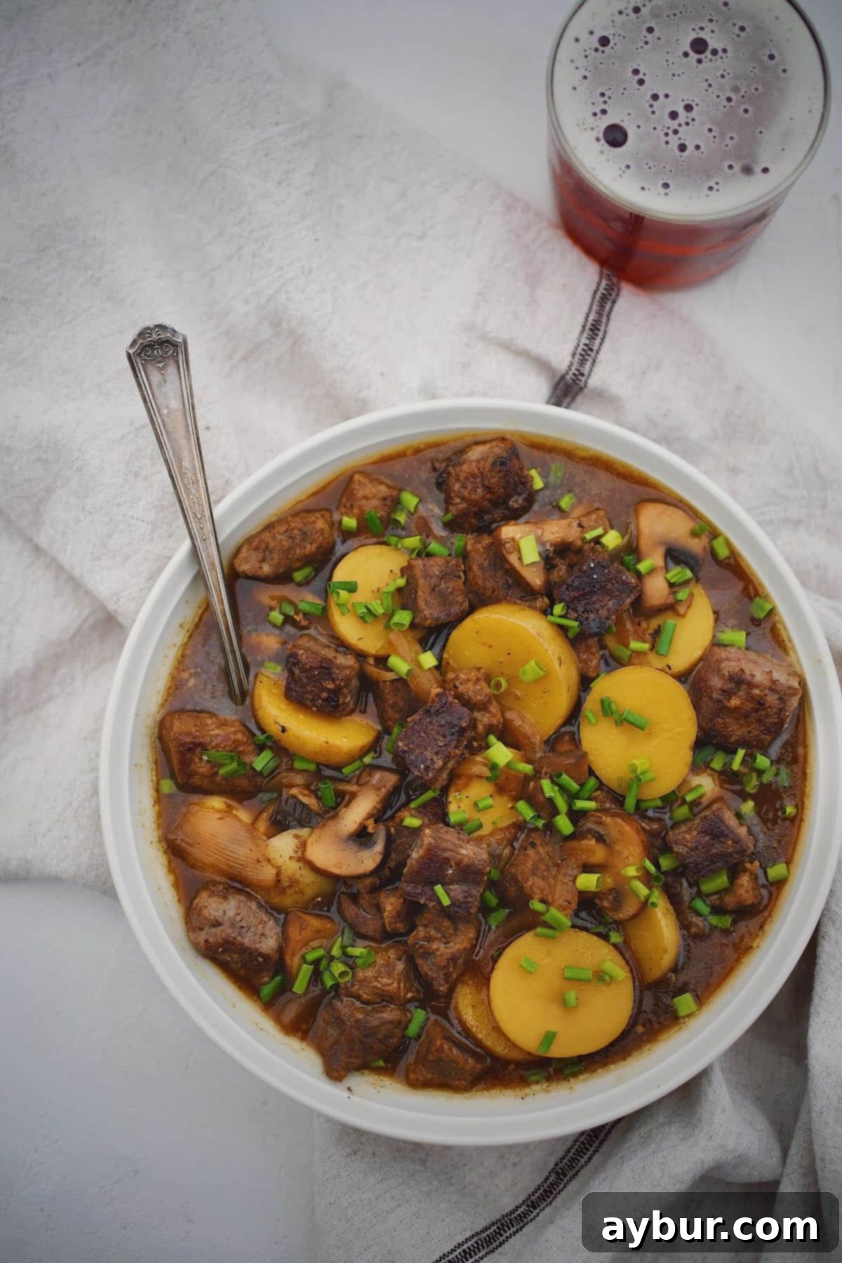 A close-up shot of a bowl of Steak and Potato Soup, showcasing the tender beef chunks, soft potatoes, and rich broth, inviting diners to enjoy.