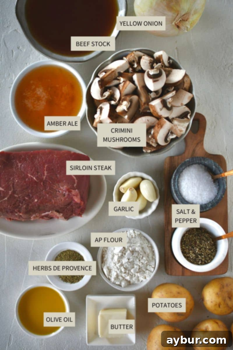 A selection of fresh ingredients laid out on a wooden board, including cubed steak, potatoes, onions, mushrooms, garlic, and herbs, ready for making Steak and Potato Soup.