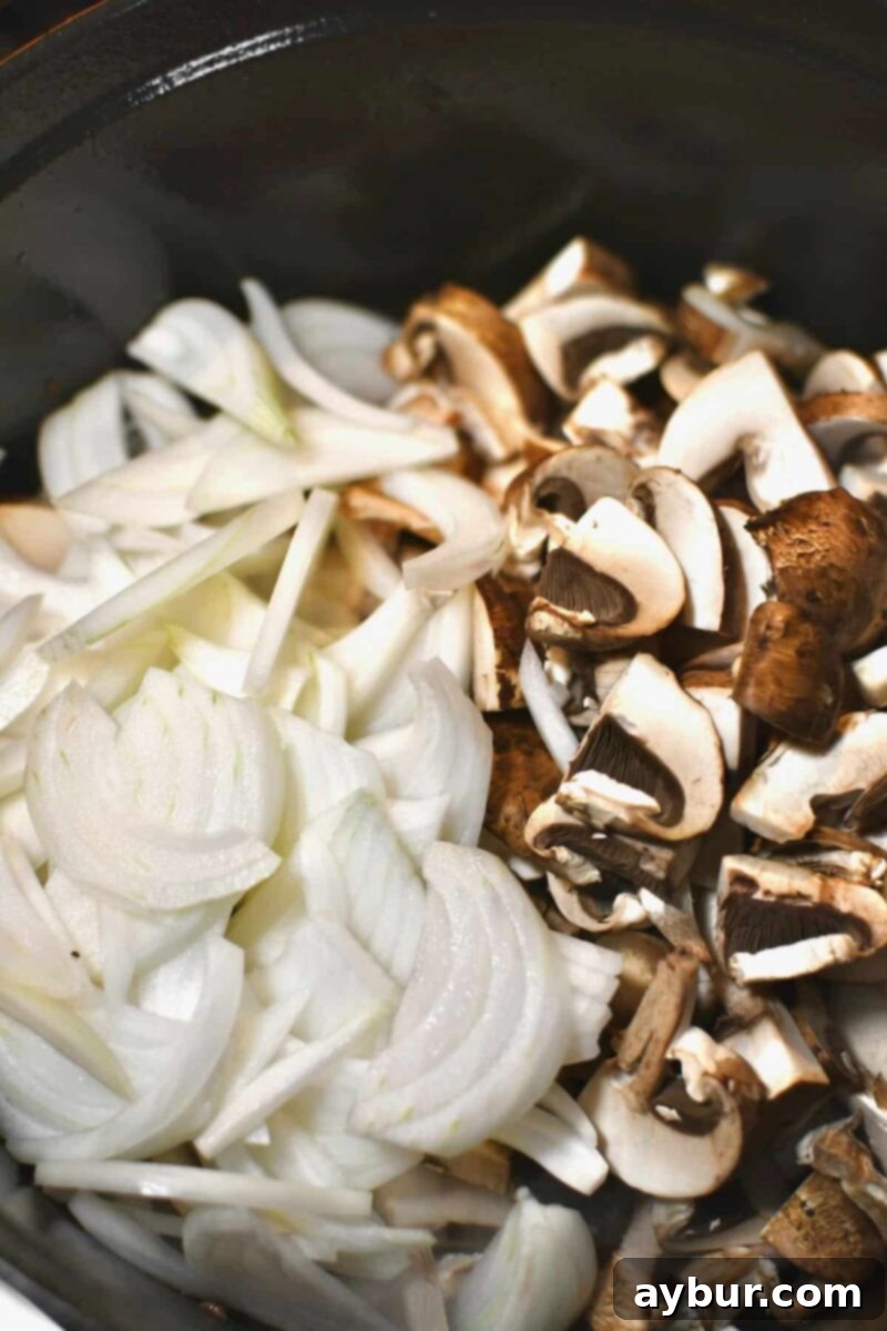 Adding sliced onions and mushrooms to the pot after the seared steak has been removed, to caramelize them.