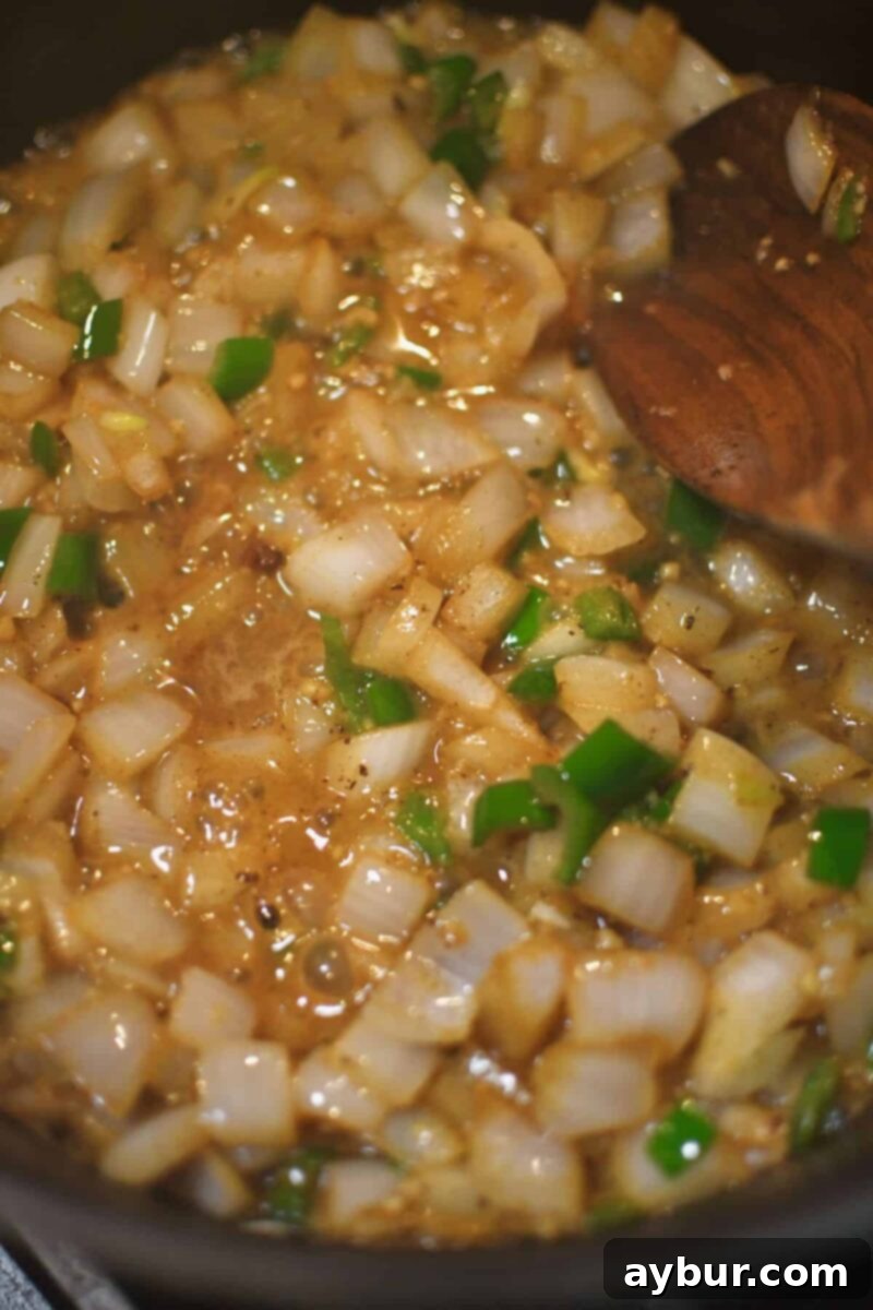 Sweating the onions and serrano chilis in butter and bacon fat.