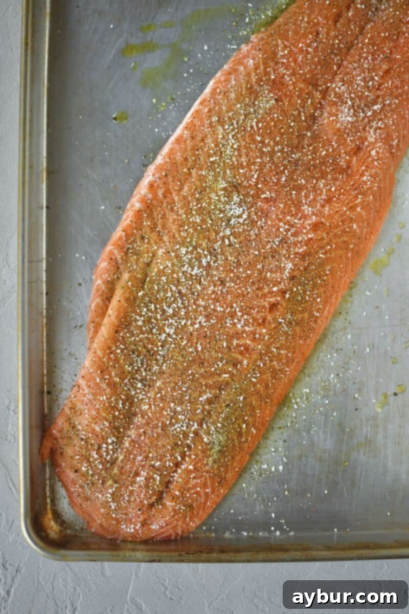 Zesty Greek Salmon 5 Seasoning the salmon side with Greek seasoning, salt, and pepper.