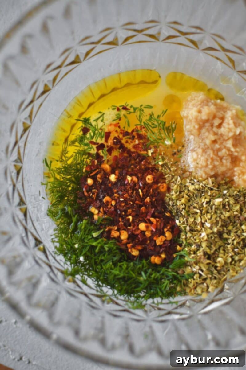 Zesty Greek Salmon 6 Mixing up olive oil, lemon juice, dill, oregano, garlic, and chili flakes to make salmon marinade.