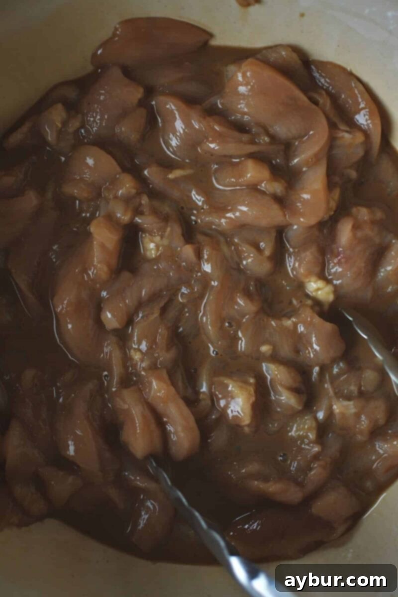 Marinating the sauce in the chicken.