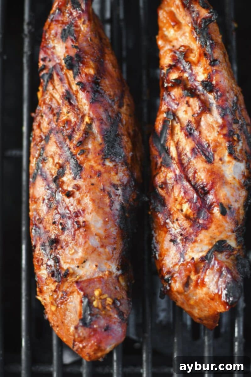 Pork Tenderloins cooking on the grill after being seared and browned, moving to indirect heat.
