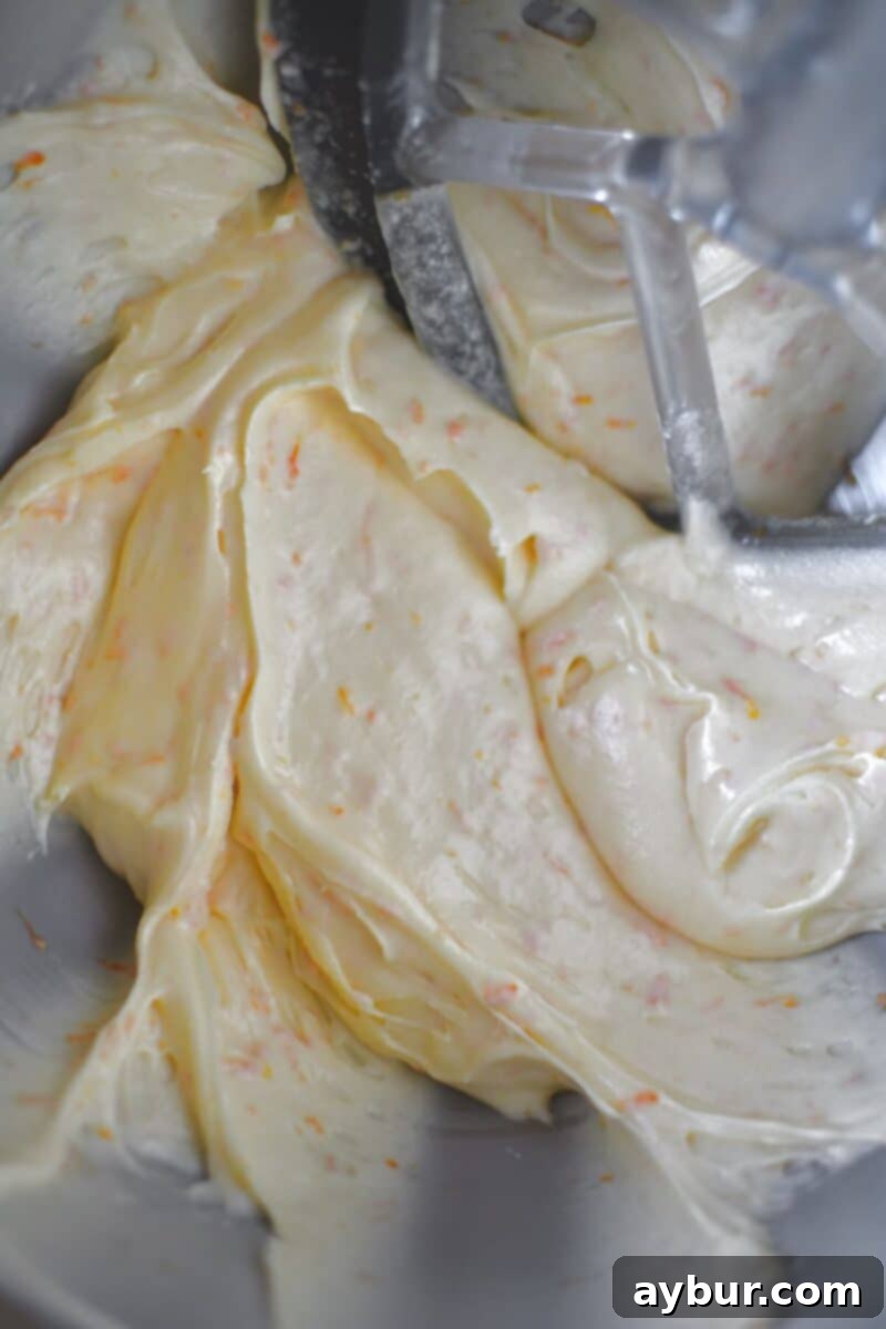 Spiced Carrot Cake Cookies 11 Whipped frosting, light and fluffy, ready to be spread generously on the cooled carrot cake cookies.