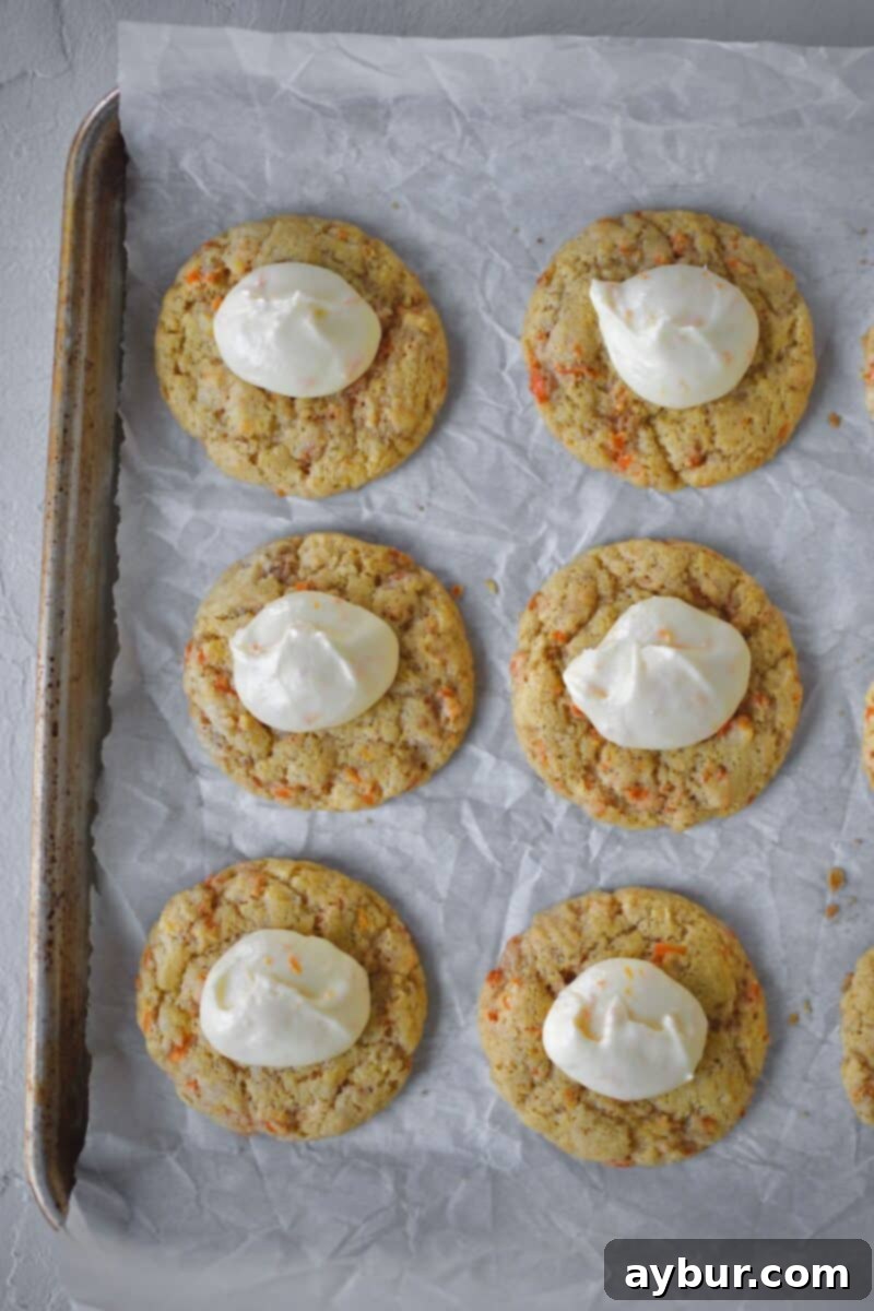 Spiced Carrot Cake Cookies 12 Adding dollops of frosting to the cookies before spreading it out evenly with a spatula for consistent coverage.