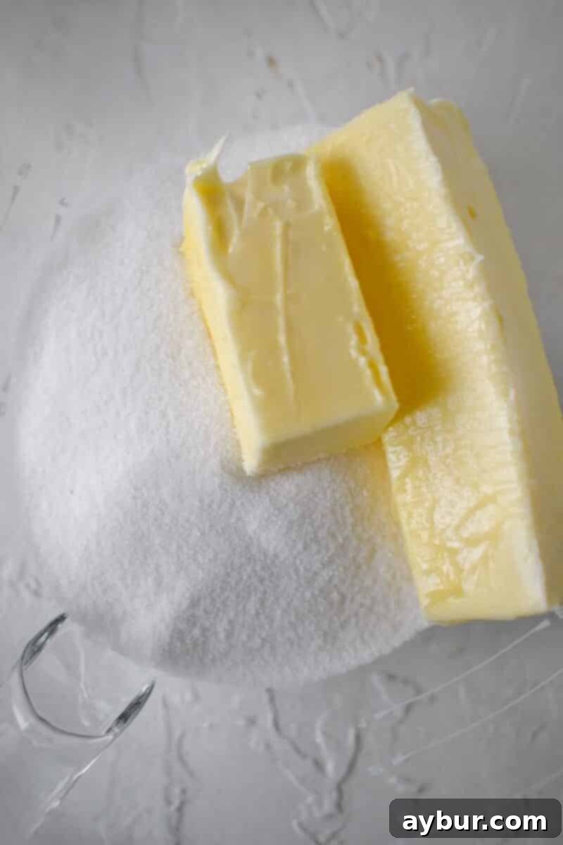 Spiced Carrot Cake Cookies 4 Sugar and butter added to a stand mixer bowl, ready to be creamed until light and fluffy.