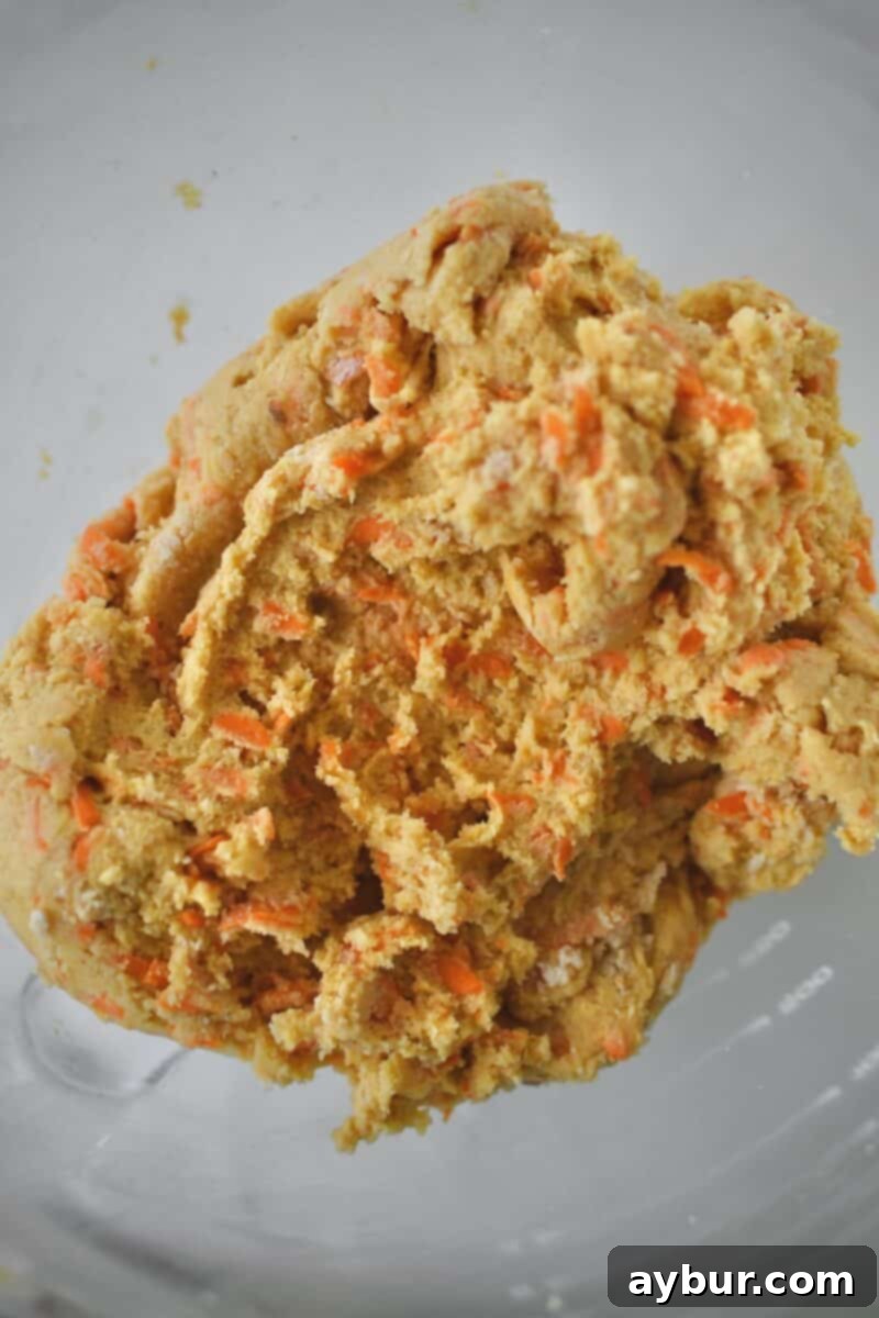 Spiced Carrot Cake Cookies 7 Cookie dough fully formed in the stand mixer bowl, ready for scooping and baking. The carrots are evenly distributed throughout.