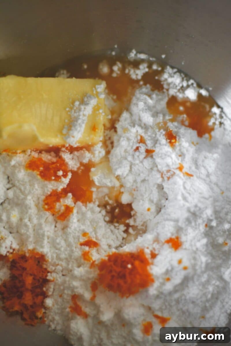 Spiced Carrot Cake Cookies 10 Making the frosting: softened butter, powdered sugar, fresh orange juice, and zest combined in a mixer bowl.