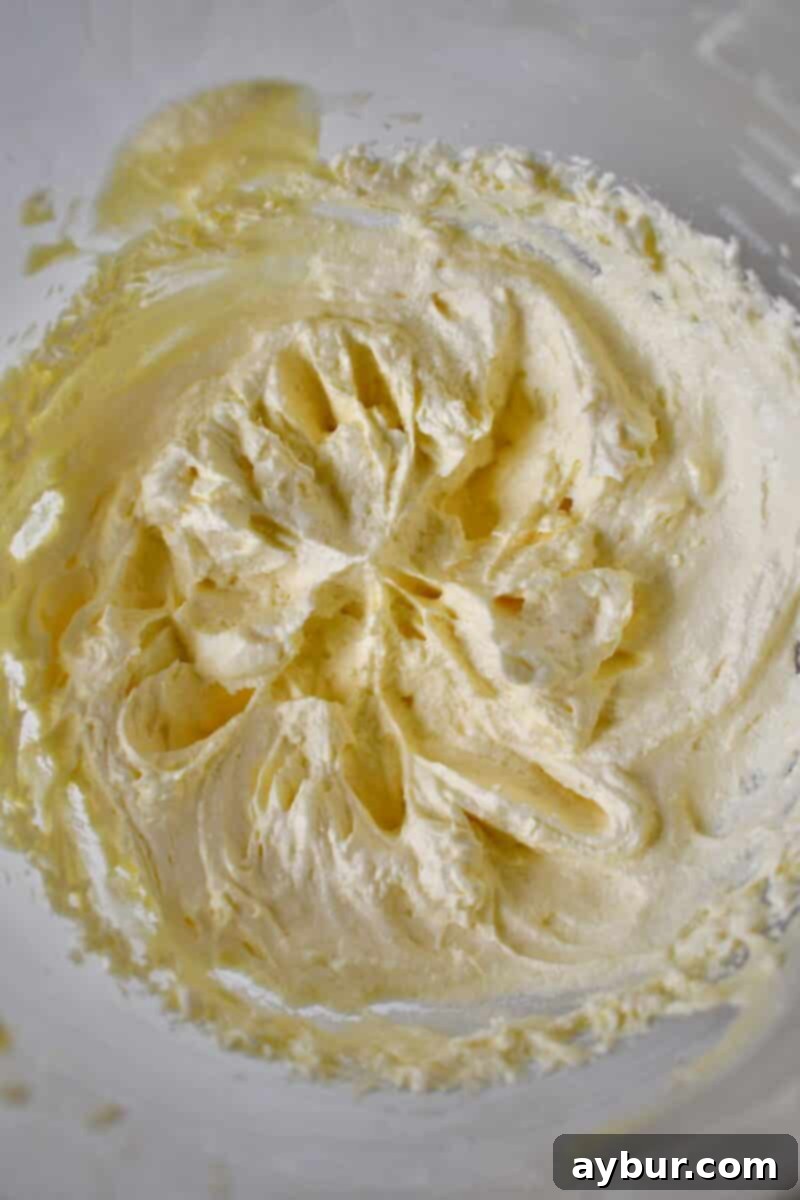 Ultimate Banana Split Cake 7 The perfectly whipped, light, and fluffy filling showcased in a stand mixer bowl, ready for layering into the Banana Split Cake.