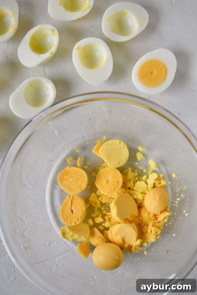 Crispy Deviled Eggs 4 Boiled eggs that have been cut in half and the yolks removed to a bowl.