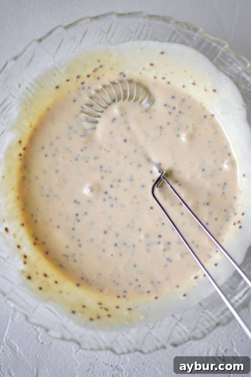 Zesty Honey Mustard Dressing 5 All ingredients for the honey mustard dressing added to a bowl, after whisking together.