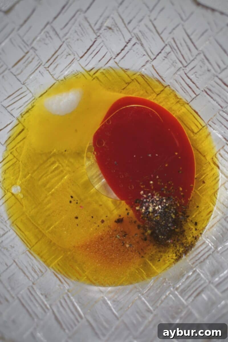 Fresh Garden Medley 4 All the marinade ingredients, including oil, vinegar, Chamoy, salt, pepper, and roasted garlic powder, in a bowl before being whisked.