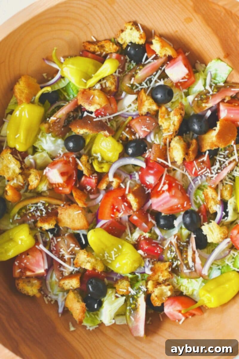 Fully prepped Italian salad with all toppings artfully arranged, ready for final tossing.