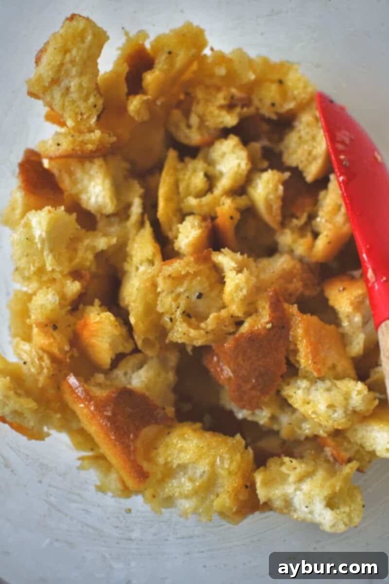 Torn bread tossed with the seasoned butter until well coated.