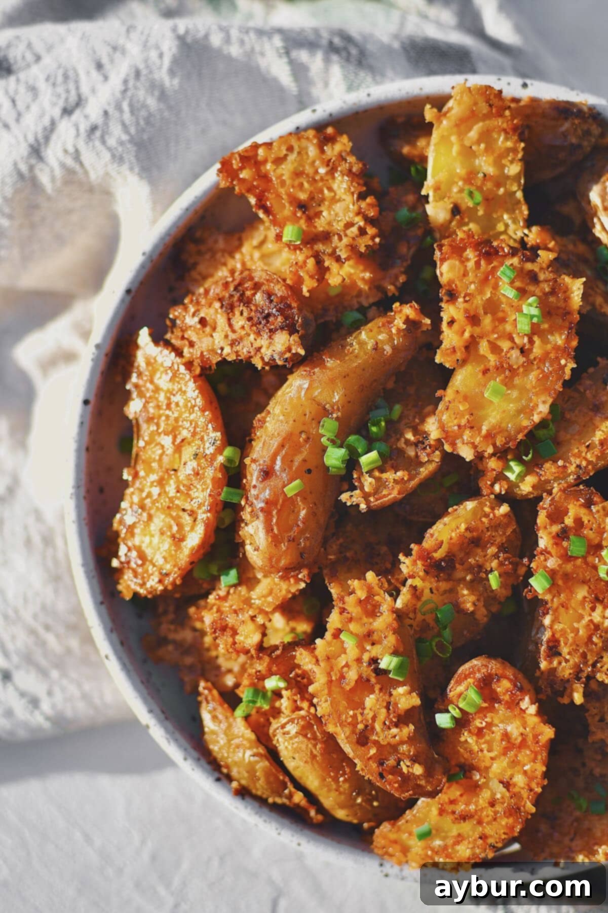 Parmesan Crusted Potatoes that have baked and cooled, in a serving bowl.