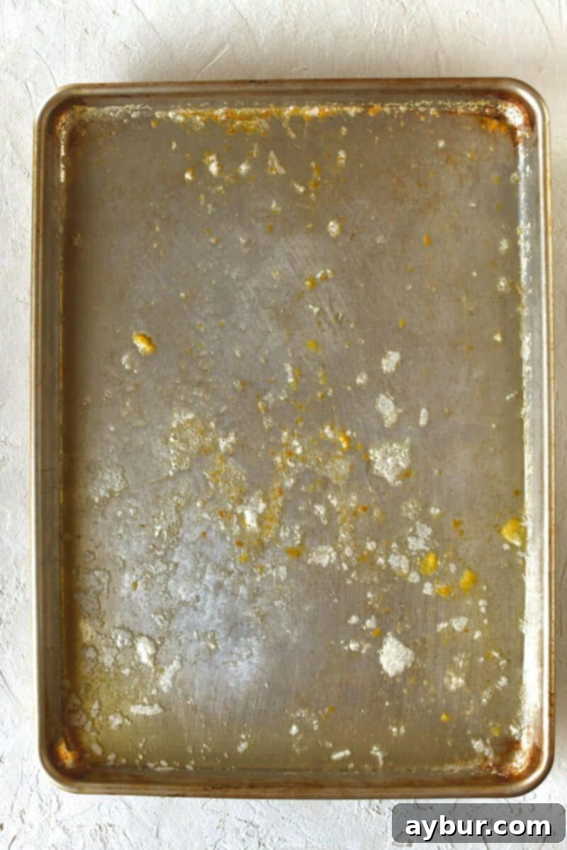 Solid butter placed on a rimmed baking sheet after melting.