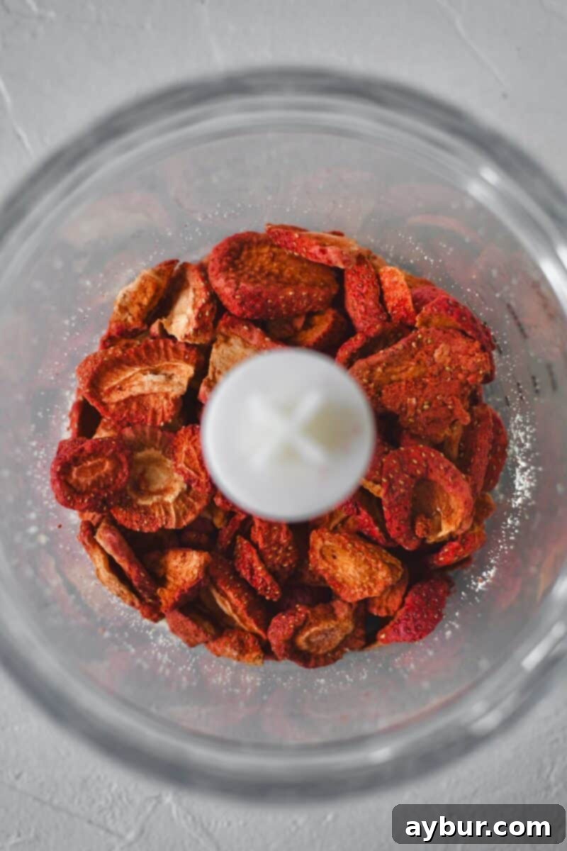 Freeze dried strawberries before crushing in a food processor.
