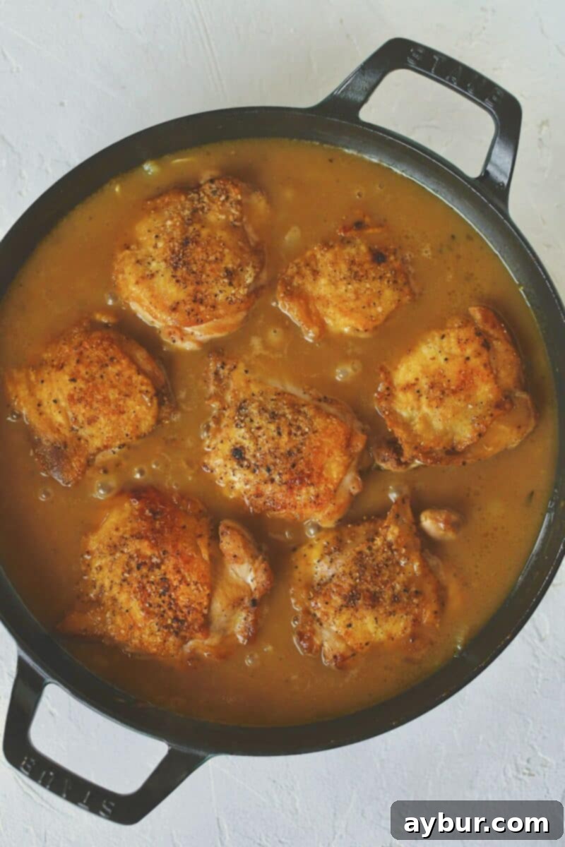 Caramelized French Onion Chicken 9 Adding the seared chicken back into the skillet with the simmering onion sauce.