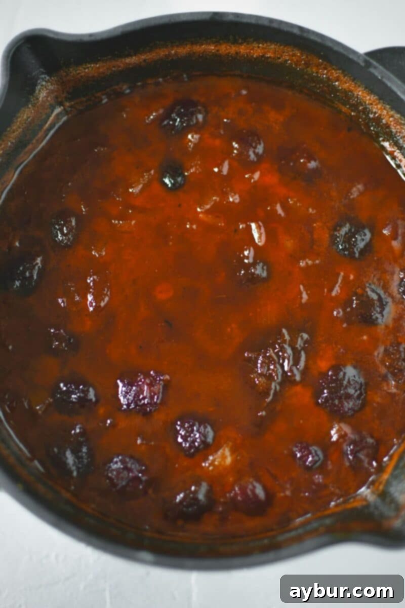 The BBQ sauce mixture gently boiling in the saucepan before being pureed to a smooth consistency.