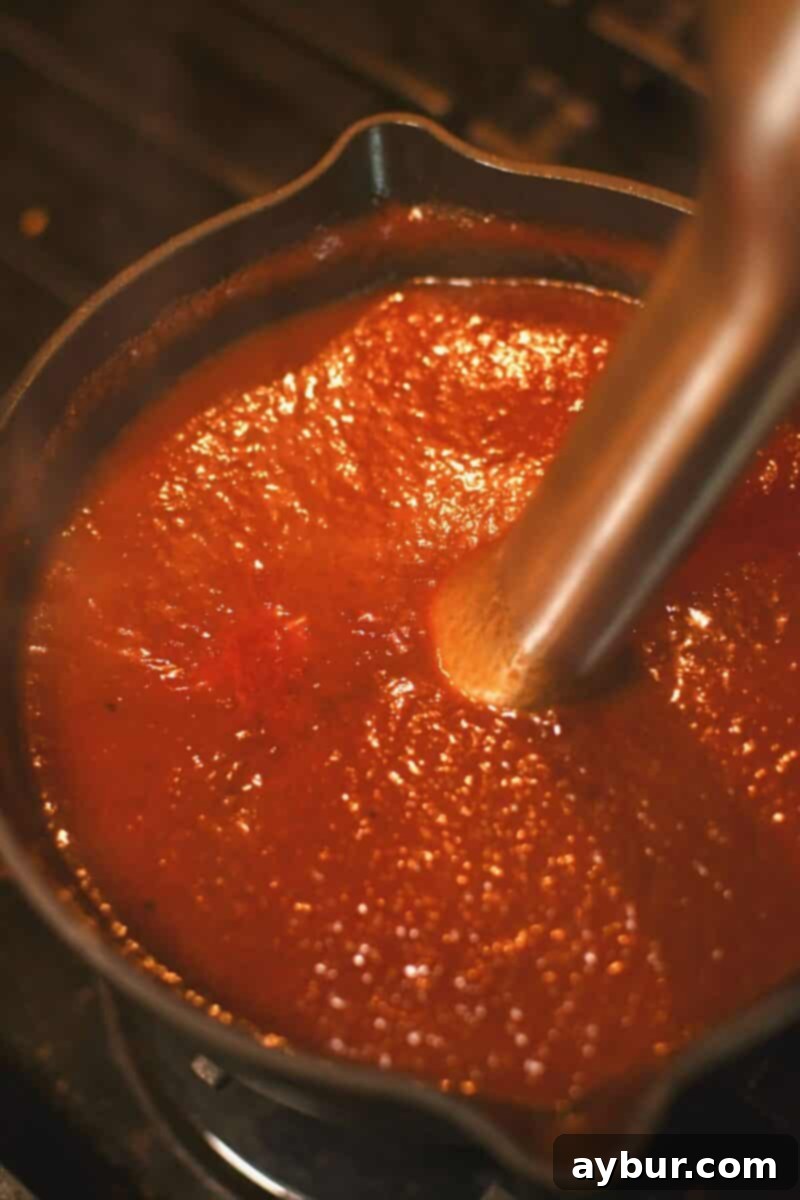The Dr. Pepper BBQ sauce, now smooth and uniform after being pureed with an immersion blender.