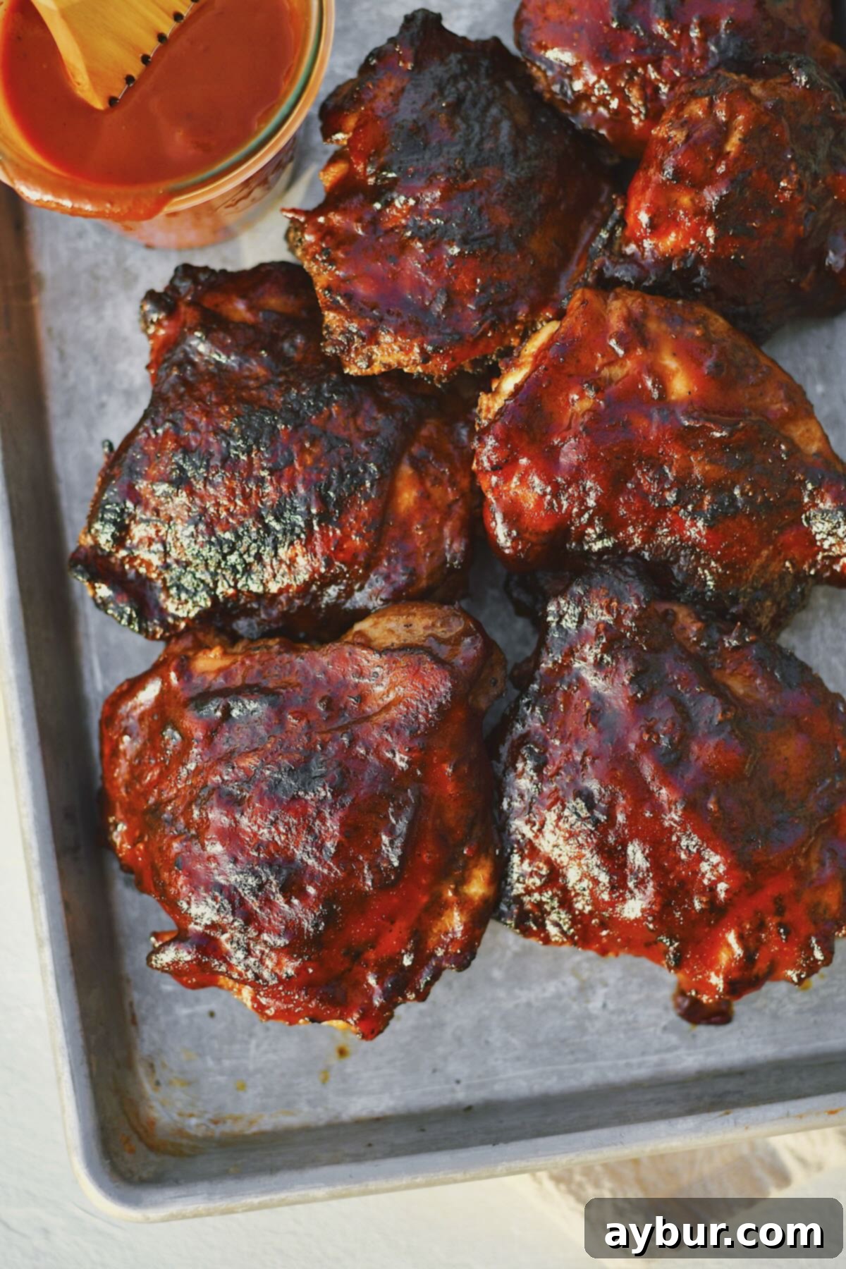 Ultimate Grilled Chicken Thighs 9 Grilled Chicken Thighs fresh off the grill and slathered in bbq sauce.