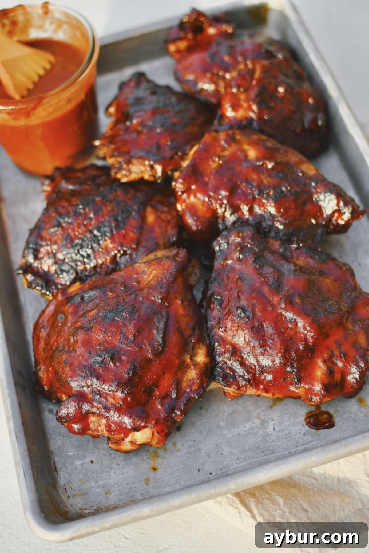 Ultimate Grilled Chicken Thighs 10 Grilled Chicken Thighs fresh off the grill and slathered in bbq sauce.