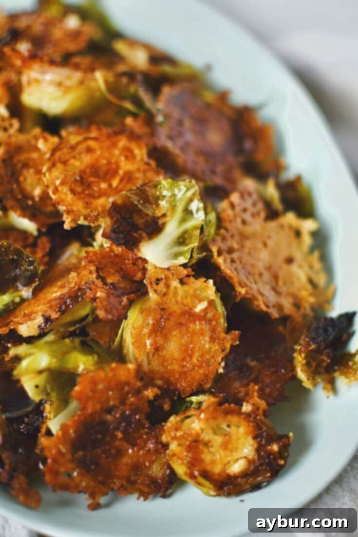 A beautifully plated serving of crispy Parmesan Brussels Sprouts, showcasing their golden-brown edges and delicious cheese crust.