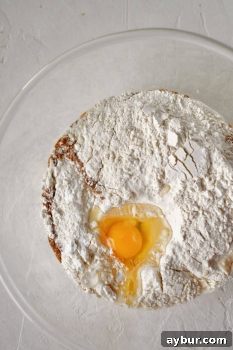 Warm Spiced Apple Pancakes 4 All the dry and wet ingredients for the pancake batter being combined in a large mixing bowl.