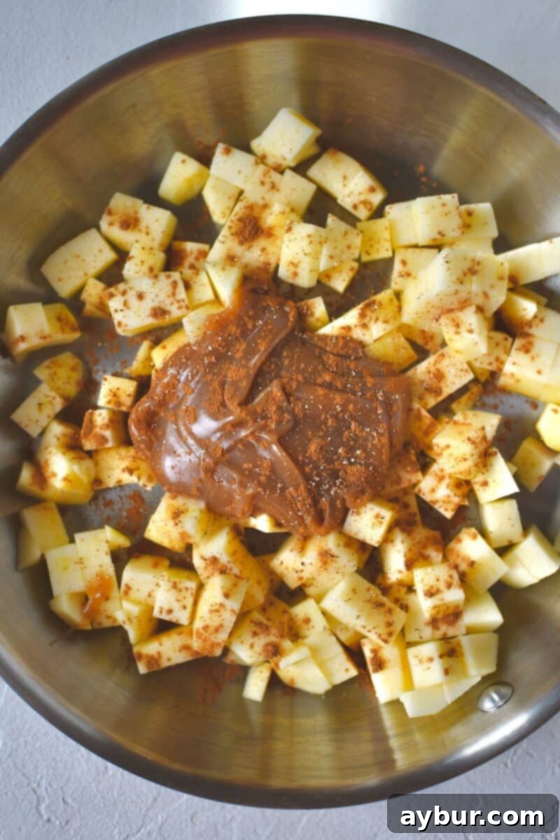 Warm Spiced Apple Pancakes 6 Freshly diced apples, rich caramel sauce, and a sprinkle of cinnamon perfectly combined in a skillet, ready to be cooked into a luscious topping.