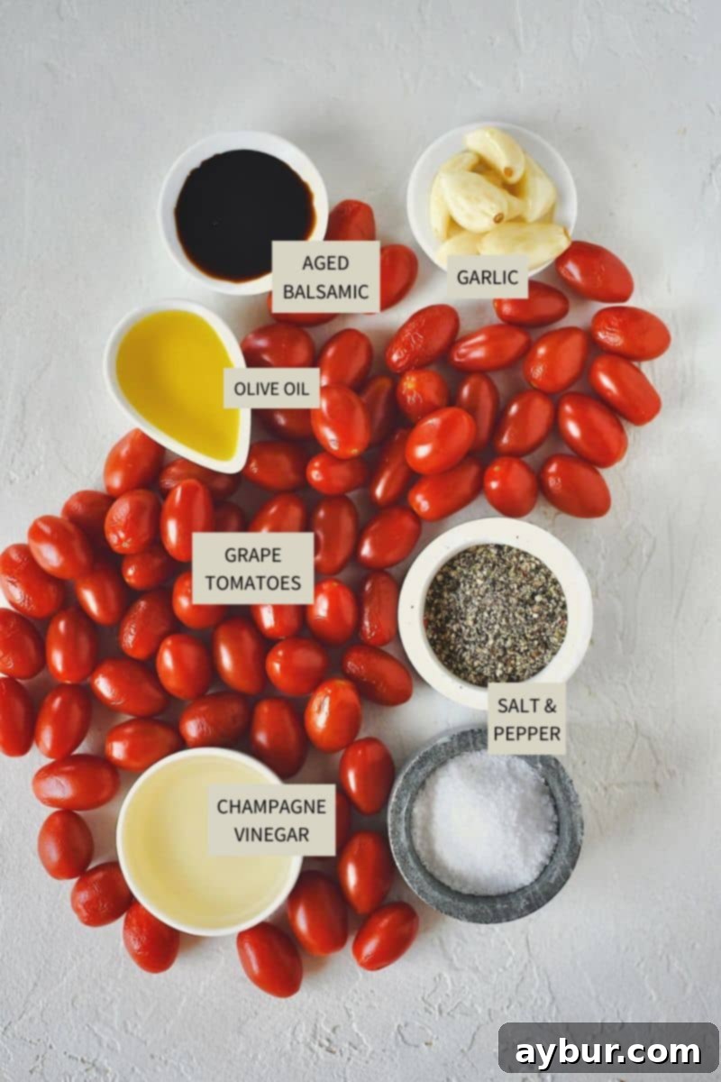 Fire-Kissed Tomato Vinaigrette 3 Fresh ingredients laid out for making Roasted Tomato Vinaigrette, including grape tomatoes, garlic cloves, olive oil, and vinegars.