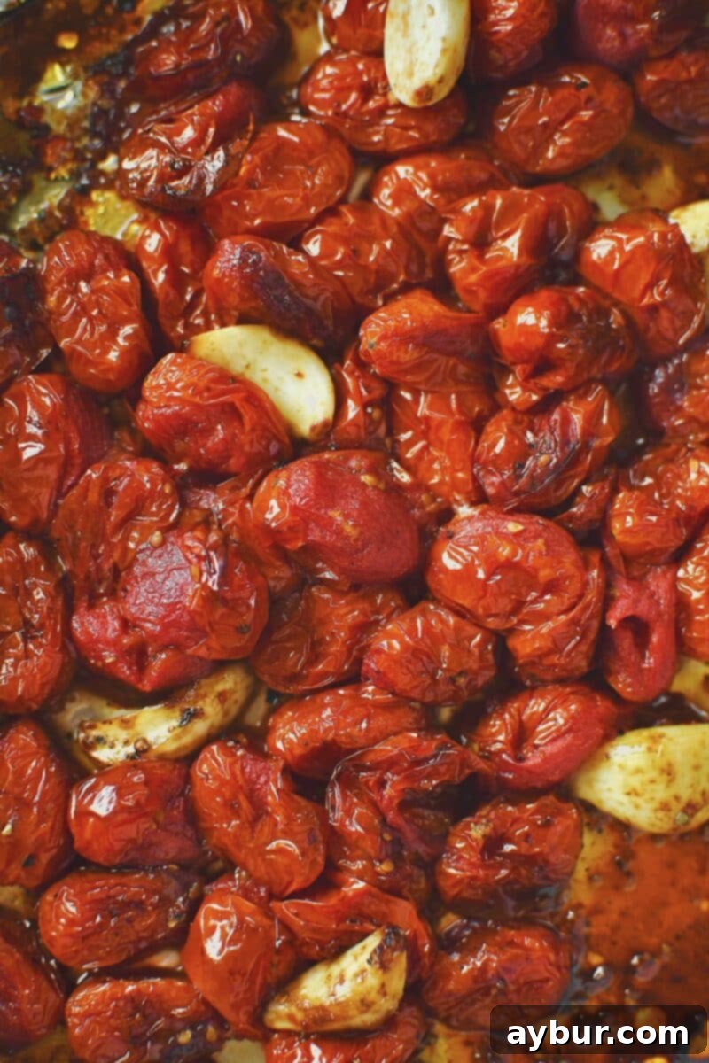 Fire-Kissed Tomato Vinaigrette 5 Roasted grape tomatoes and garlic on a baking sheet, golden and slightly charred, ready for blending.