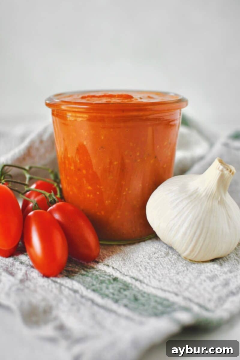Fire-Kissed Tomato Vinaigrette 7 The finished Roasted Tomato Vinaigrette, blended smooth and poured into a glass jar, ready for use.