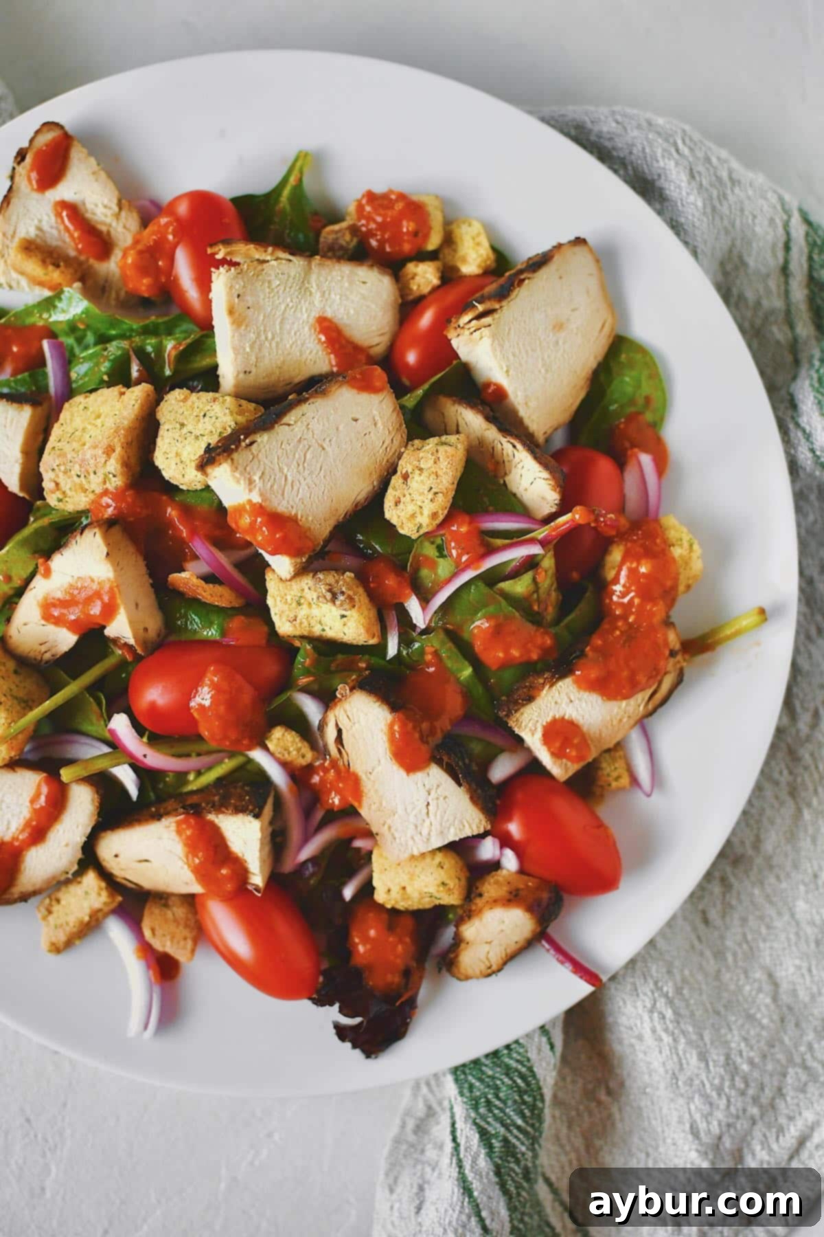 Fire-Kissed Tomato Vinaigrette 9 A close-up of a vibrant salad featuring Roasted Tomato Vinaigrette, highlighting its rich color and inviting texture.