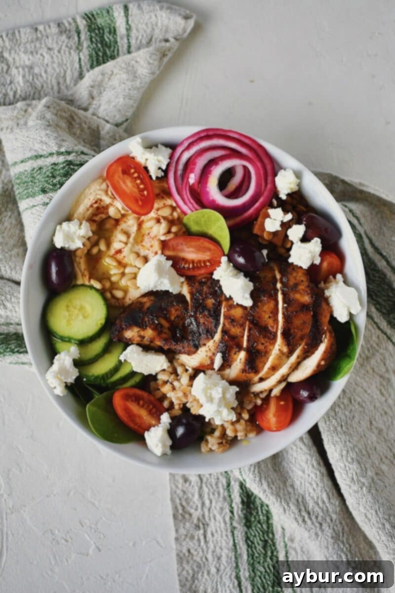 Vibrant Mediterranean Harvest Bowl 8 The finished Mediterranean Bowl, beautifully adorned with grape tomatoes, crumbled feta cheese, and Kalamata olives.