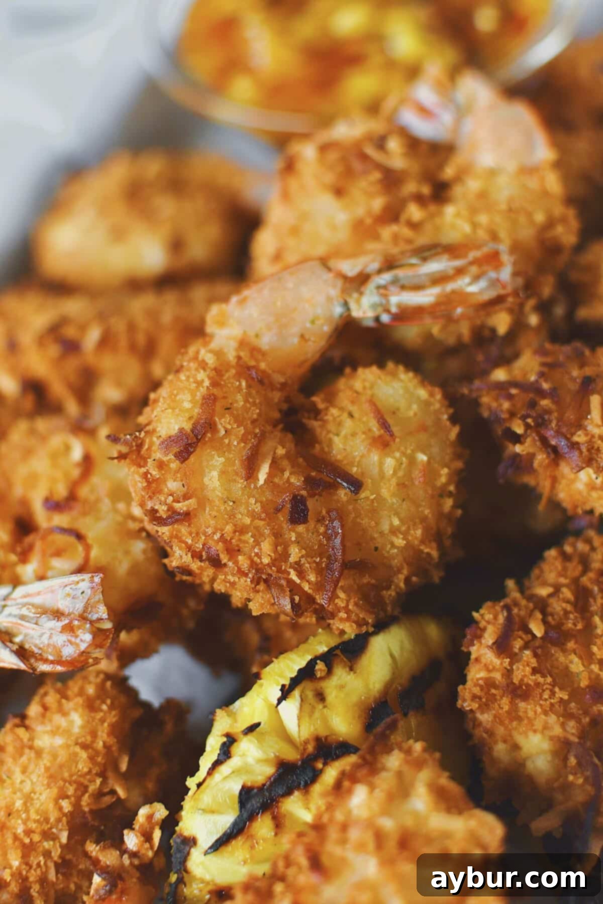 Freshly fried golden-brown Coconut Shrimp, hot and perfectly crispy, ready to be enjoyed as an appetizer or main course.