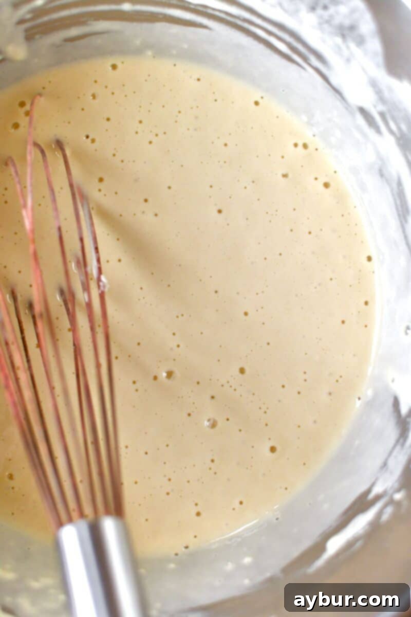 A bowl of smoothly whisked wet batter, ready for dipping shrimp.