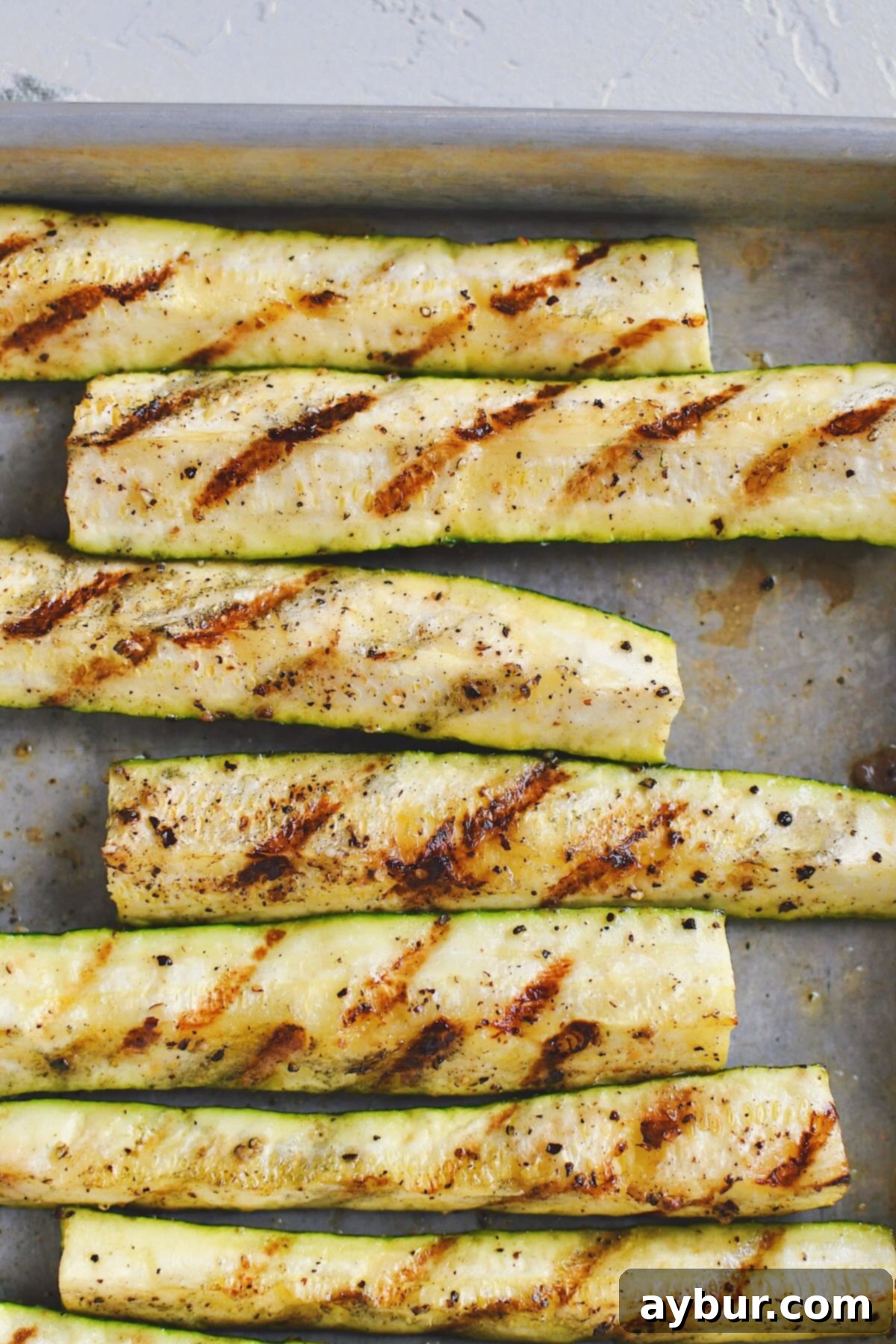Freshly Grilled Zucchini spears, perfectly charred and ready to serve off the grill.