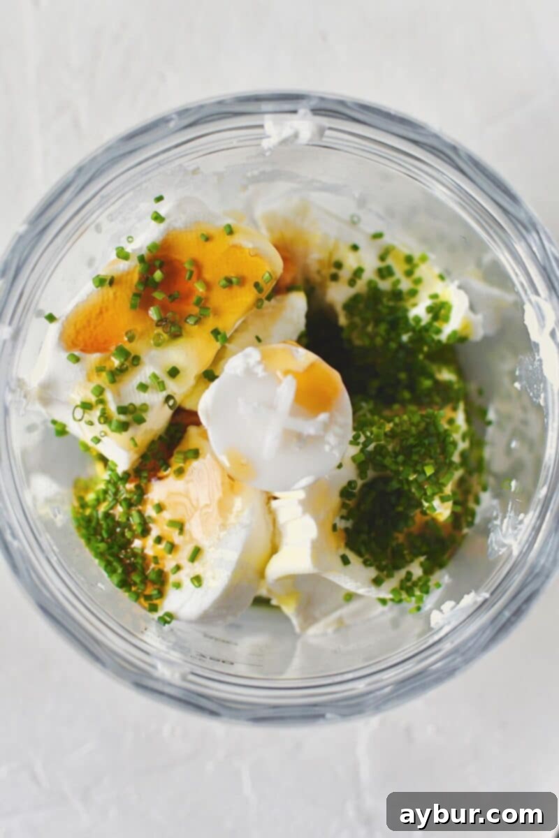 Velvet Goat Cheese Spread 4 Goat cheese, cream cheese, wildflower honey, olive oil, chives, salt, and pepper, place in a mini food processor ready to be whipped.