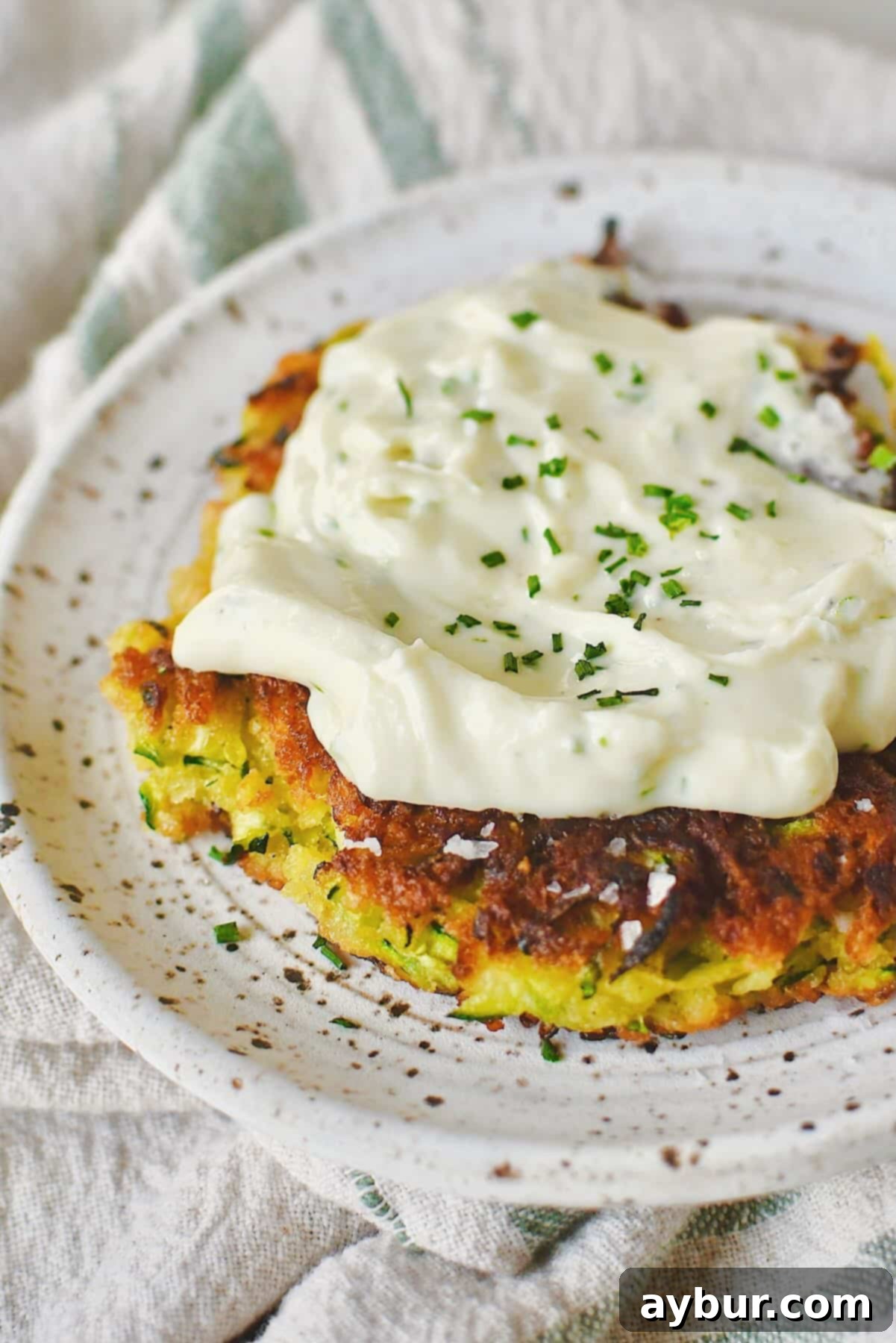 Velvet Goat Cheese Spread 8 Zucchini Fritter topped with whipped goat cheese and ready to enjoy.