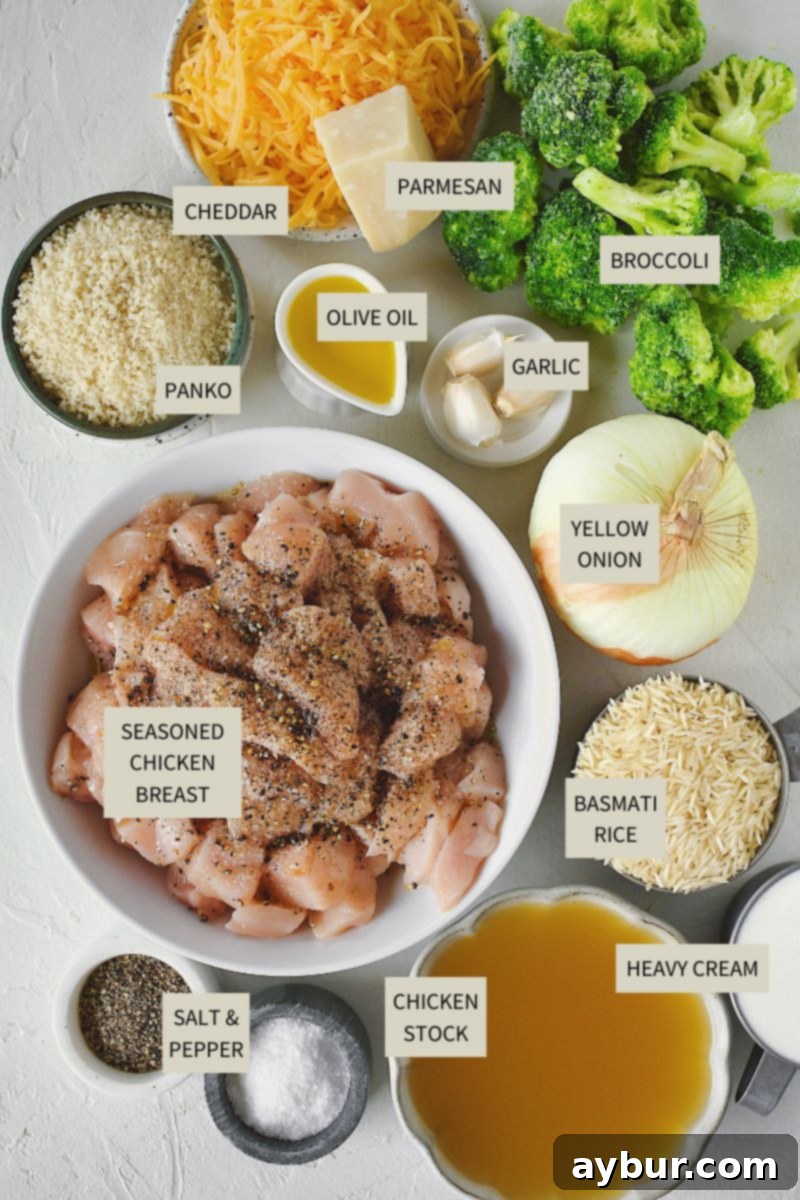 Fırında Tavuklu Brokoli Pilavı 3 A vibrant display of fresh ingredients, including chicken breast, broccoli florets, basmati rice, cheeses, and aromatics, laid out on a wooden board, ready for making Chicken and Broccoli Rice Casserole.