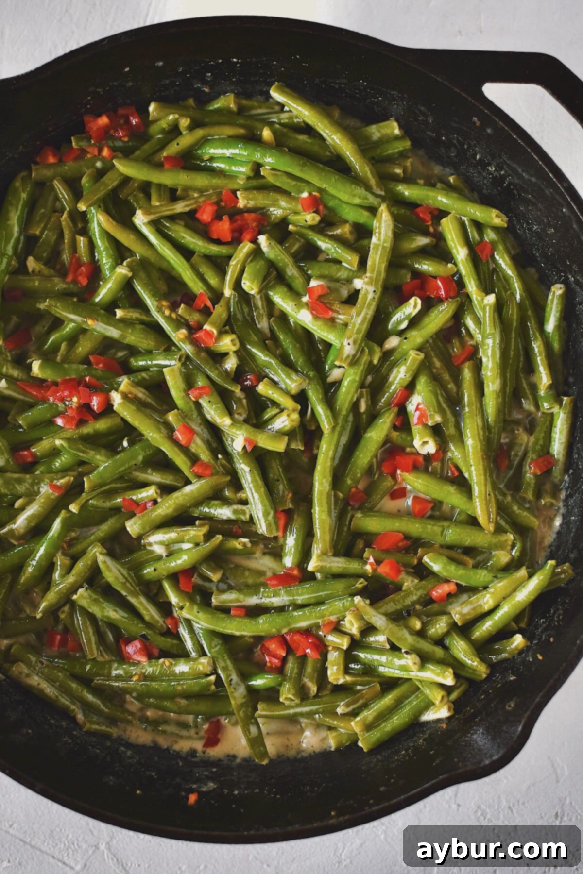 Creamy Green Beans 2 Creamed Green Beans ready to eat and topped with some diced tomatoes.