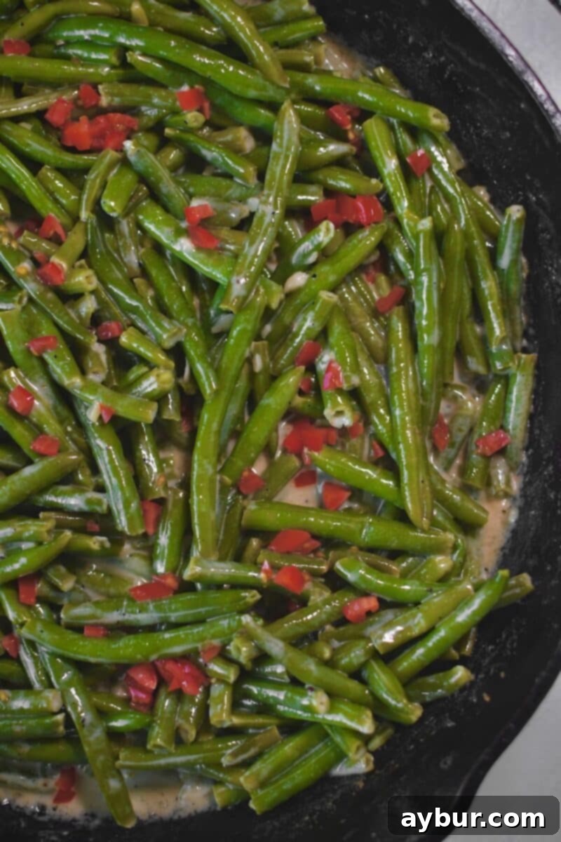 Creamy Green Beans 9 Finishing the green beans with some diced tomatoes before serving.