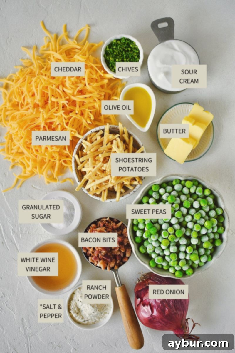 Pea Salad 3 All the fresh and packaged ingredients laid out on a kitchen counter, including peas, bacon bits, red onion, cheddar cheese, and shoestring potatoes, ready for making Bacon Pea Salad.