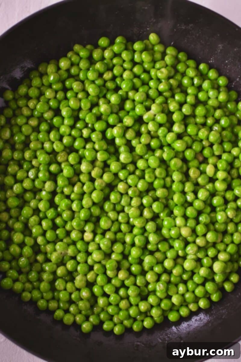 Pea Salad 4 Fresh green peas gently warming in melted butter in a pan on the stove, beginning to tenderize.