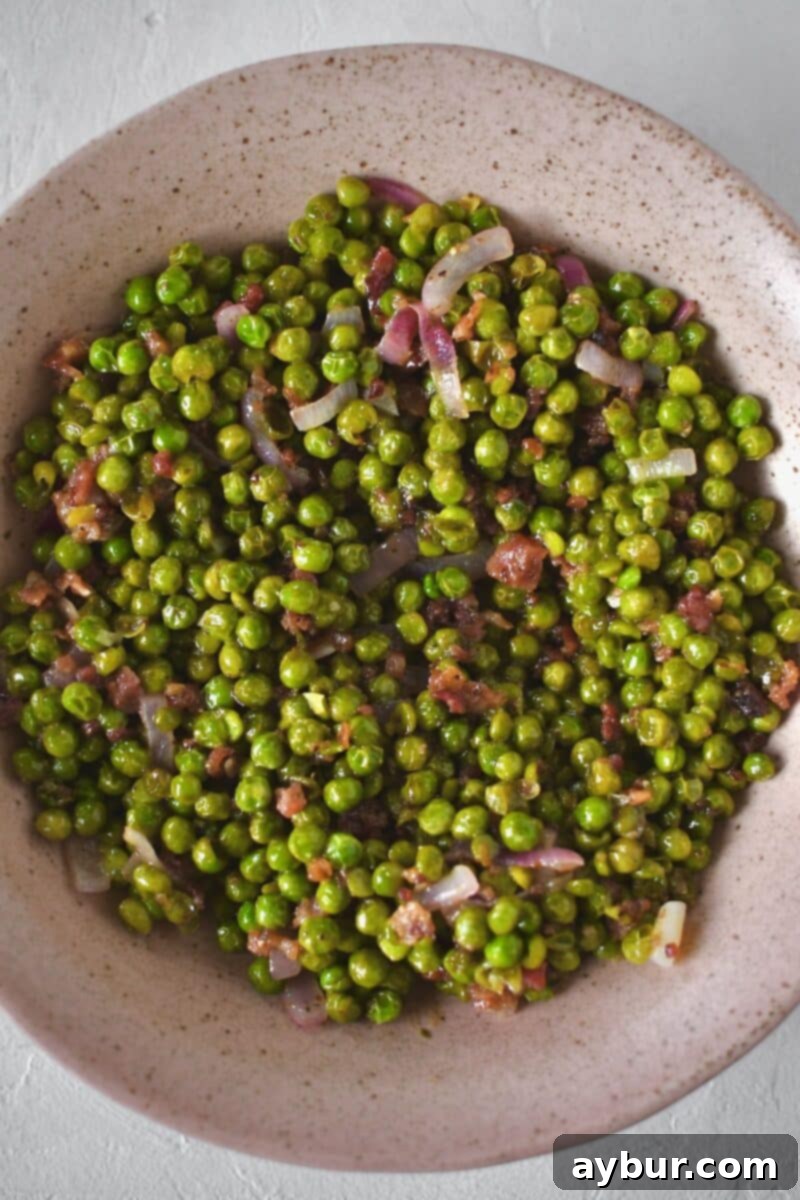 Pea Salad 7 The vibrant pea salad mixture in a serving dish after being deglazed with the vinaigrette, ready for its final toppings.
