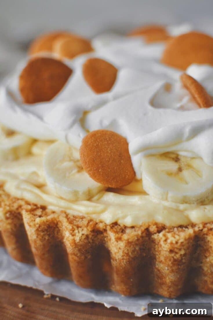 Ultimate No-Bake Banana Pudding Pie, with a creamy filling, banana slices, and a Nilla wafer crust, ready to be served.