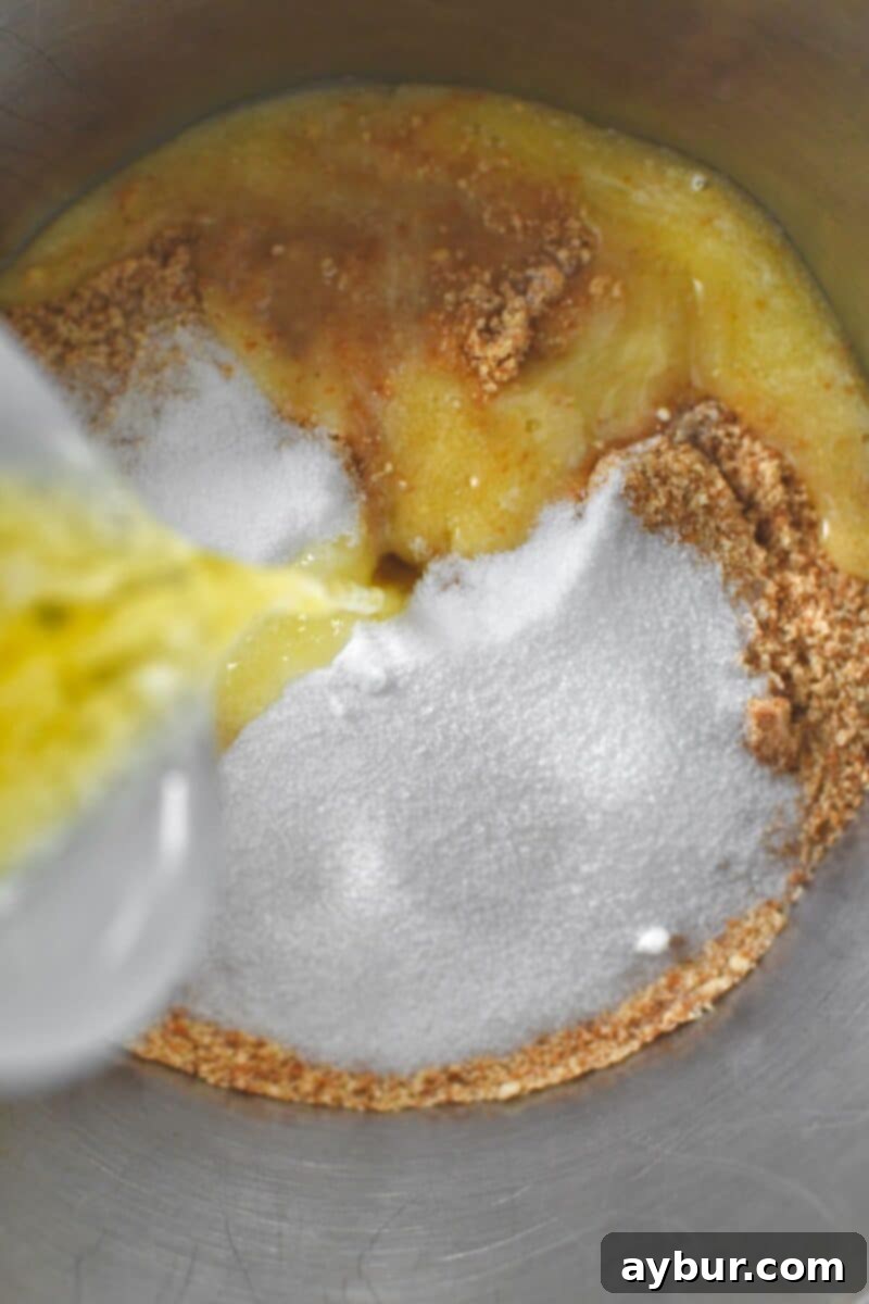Creamy Banana Dream Pie 4 Combining finely crushed Nilla wafer crumbs with granulated sugar, a pinch of nutmeg, and melted butter in a bowl to prepare the pie crust mixture.